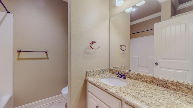 bathroom featuring tile patterned floors, vanity, and toilet