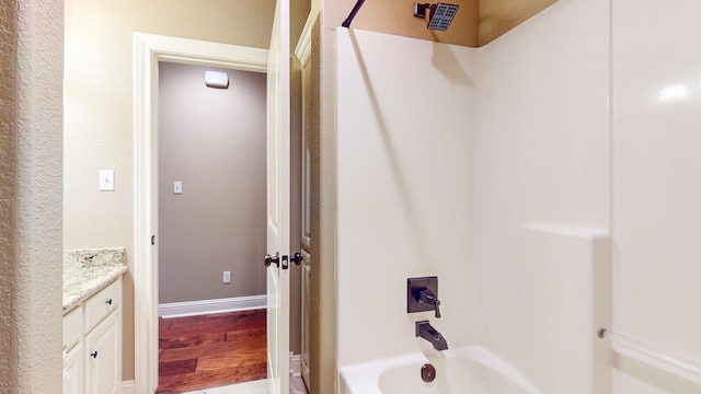 bathroom featuring vanity and  shower combination