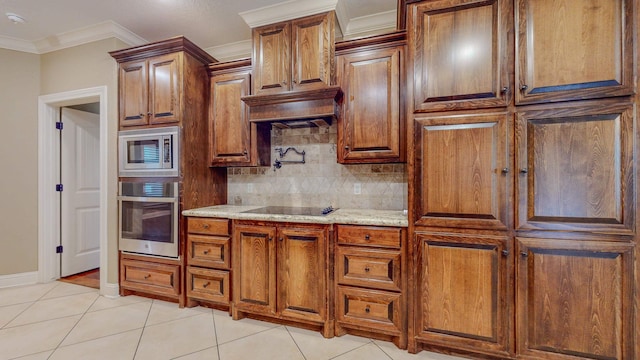 kitchen featuring appliances with stainless steel finishes, tasteful backsplash, light stone counters, ornamental molding, and light tile patterned floors