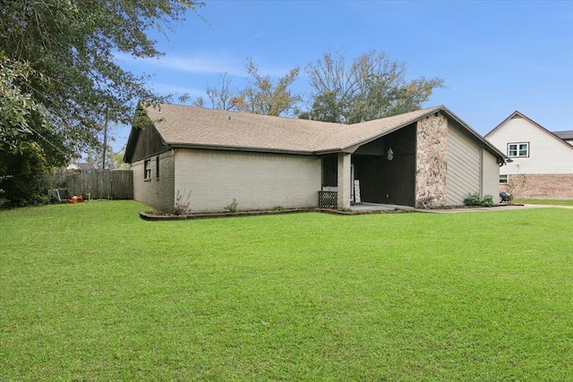 rear view of property featuring a yard