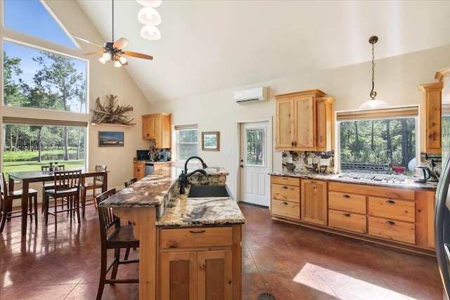 kitchen with sink, stainless steel appliances, high vaulted ceiling, decorative backsplash, and dark tile patterned flooring