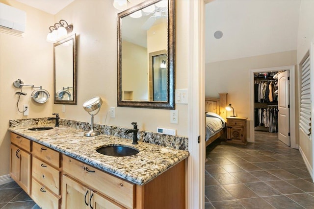 bathroom featuring an AC wall unit and vanity