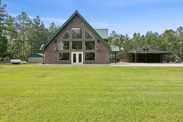 rear view of property featuring french doors and a lawn