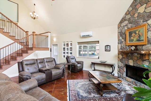 tiled living room featuring a stone fireplace, high vaulted ceiling, a chandelier, and a wall mounted air conditioner