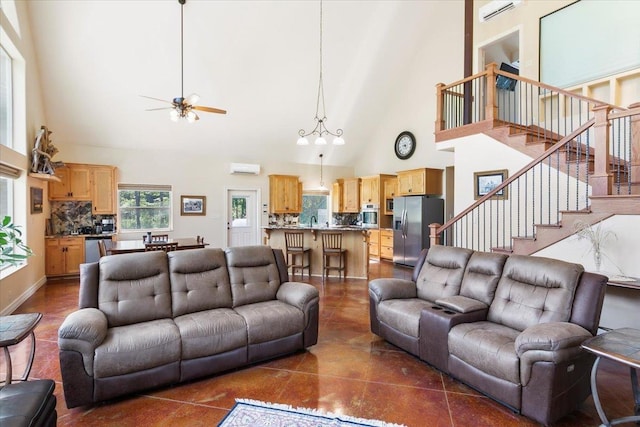 tiled living room with a high ceiling, a wall unit AC, ceiling fan, and sink