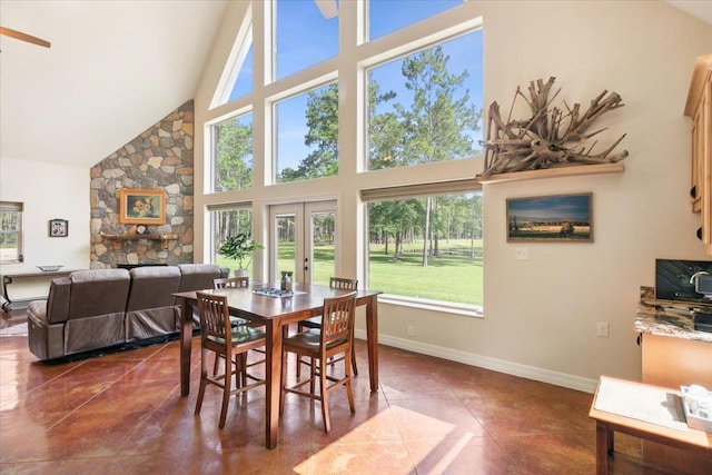 tiled dining room featuring french doors and high vaulted ceiling