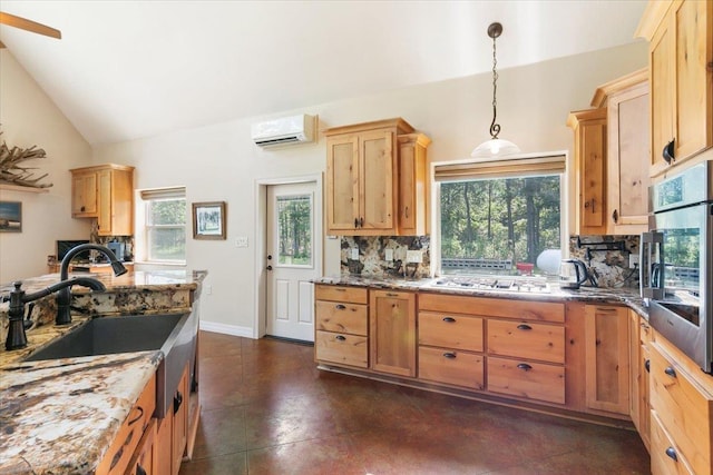 kitchen with stainless steel appliances, tasteful backsplash, a wall mounted AC, pendant lighting, and vaulted ceiling