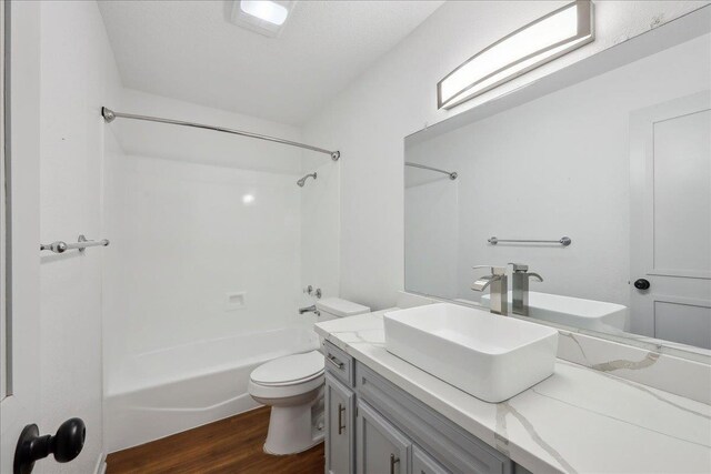 6635 Griffing Rd, Beaumont, TX 77708 - full bath with toilet, washtub / shower combination, vanity, and wood finished floors