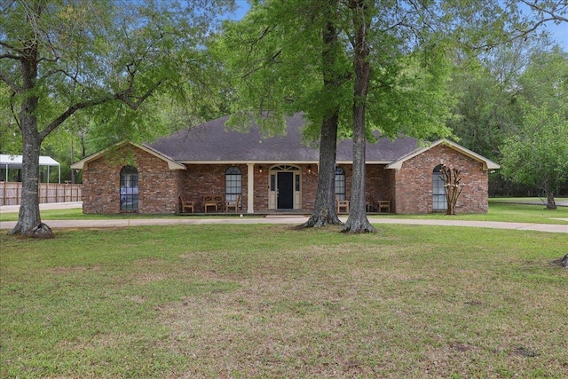 6635 Griffing Rd, Beaumont, TX 77708 - ranch-style home with a front lawn, a shingled roof, and brick siding
