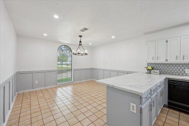 6635 Griffing Rd, Beaumont, TX 77708 - kitchen with a peninsula, dishwasher, white cabinetry, an inviting chandelier, and light tile patterned floors