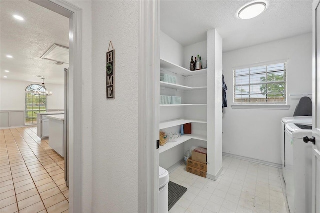 6635 Griffing Rd, Beaumont, TX 77708 - laundry room featuring a notable chandelier, separate washer and dryer, a textured ceiling, laundry area, and recessed lighting