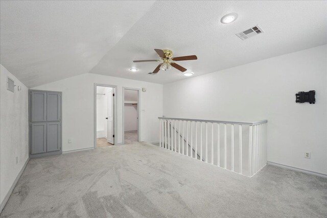 6635 Griffing Rd, Beaumont, TX 77708 - additional living space with a textured ceiling, visible vents, a ceiling fan, lofted ceiling, and light colored carpet