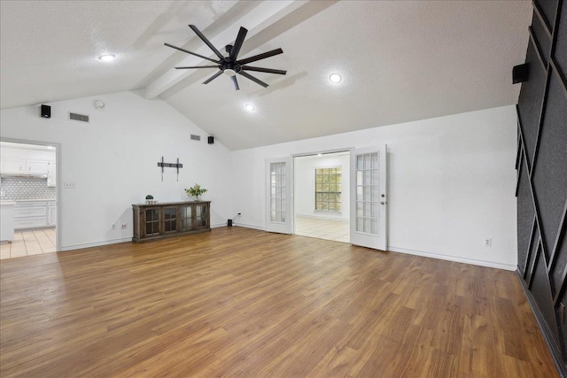 6635 Griffing Rd, Beaumont, TX 77708 - unfurnished living room with a textured ceiling, visible vents, ceiling fan, wood finished floors, and beam ceiling