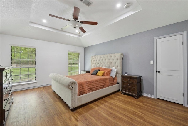 6635 Griffing Rd, Beaumont, TX 77708 - bedroom featuring a raised ceiling, light wood finished floors, baseboards, visible vents, and recessed lighting