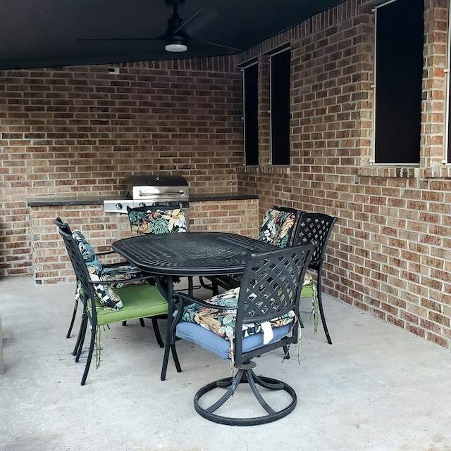 view of patio with area for grilling and ceiling fan