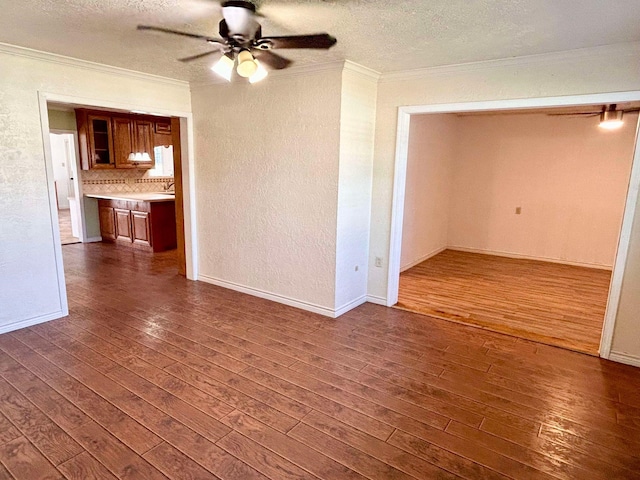 unfurnished living room with a textured ceiling, dark hardwood / wood-style flooring, and ceiling fan