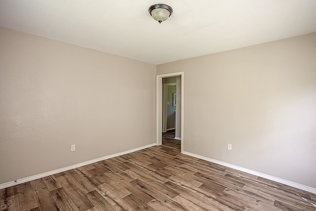 spare room featuring wood-type flooring