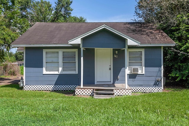 view of front facade with cooling unit and a front yard