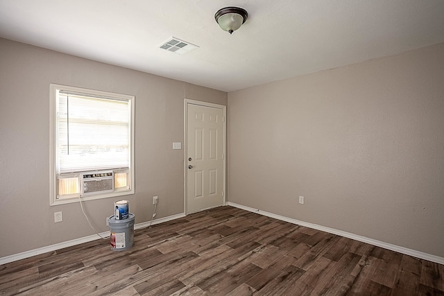 empty room with dark hardwood / wood-style flooring and cooling unit