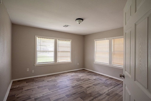 spare room with light hardwood / wood-style flooring