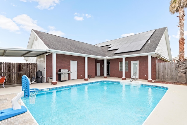 view of pool featuring a grill and a patio