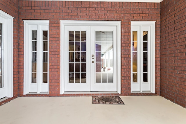 property entrance featuring a patio area and french doors