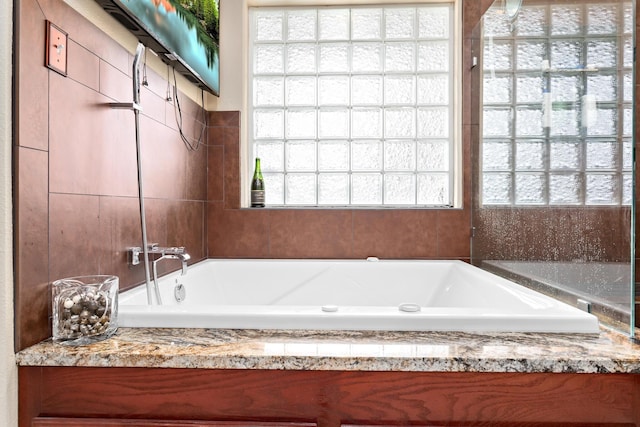 bathroom with a tub to relax in