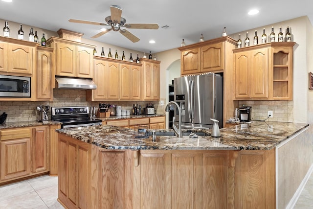 kitchen featuring ceiling fan, stainless steel appliances, stone countertops, decorative backsplash, and light tile patterned floors