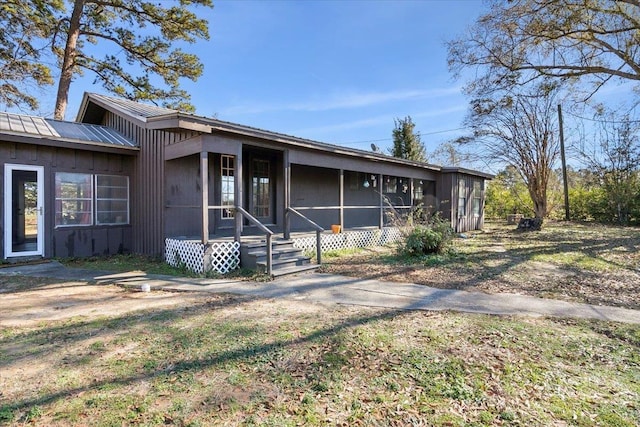 view of front of property with a front lawn and a sunroom