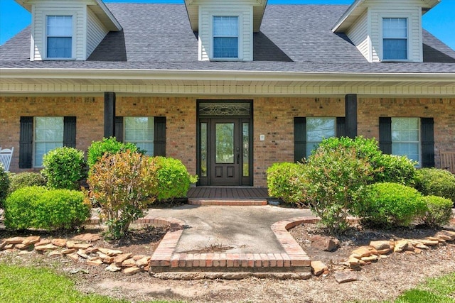 view of exterior entry with covered porch