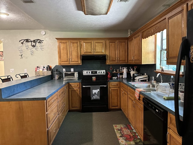 304 County Road 773, Buna, TX 77612 - kitchen with black appliances, extractor fan, a peninsula, dark countertops, and a textured ceiling