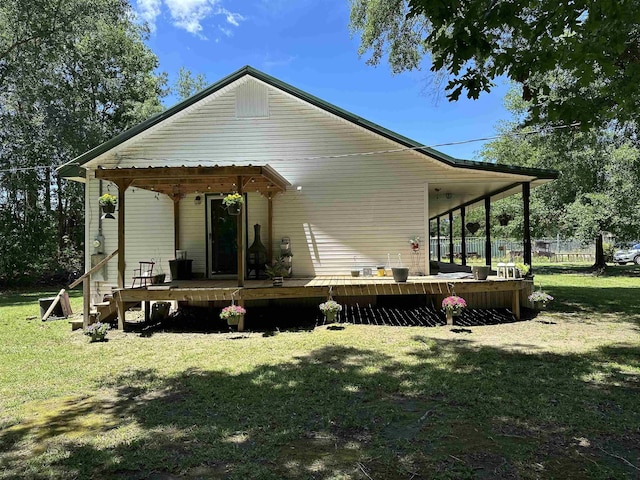 304 County Road 773, Buna, TX 77612 - back of property featuring a lawn and a deck