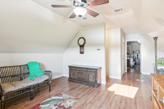 sitting room with ceiling fan, lofted ceiling, and light wood-type flooring