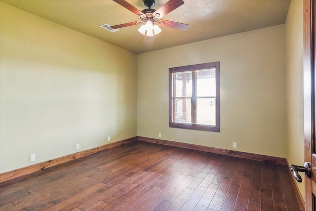 unfurnished room featuring ceiling fan and dark wood-type flooring