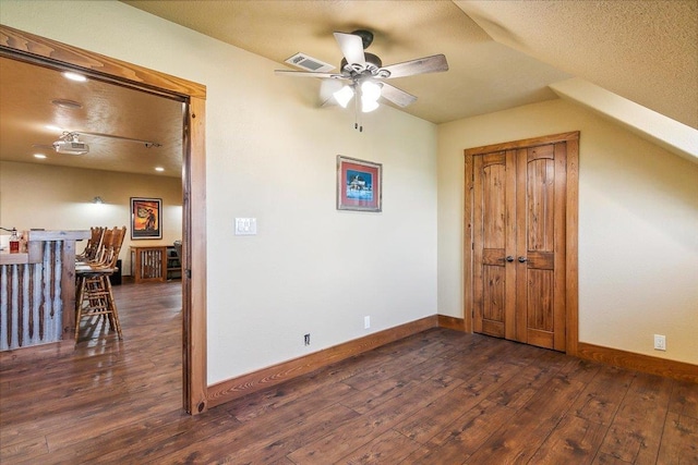 unfurnished room featuring dark hardwood / wood-style floors, ceiling fan, and lofted ceiling