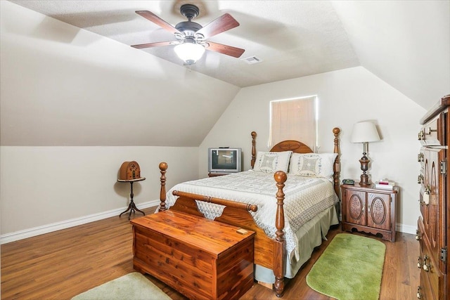 bedroom featuring ceiling fan, wood-type flooring, and lofted ceiling