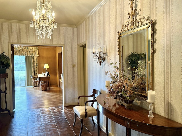 hall with tile patterned floors, crown molding, and an inviting chandelier