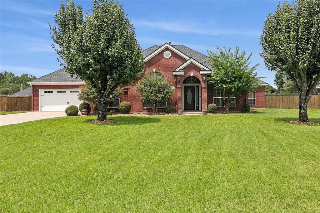 view of front of property featuring a garage and a front lawn