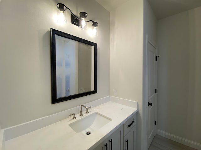 bathroom featuring hardwood / wood-style floors and vanity