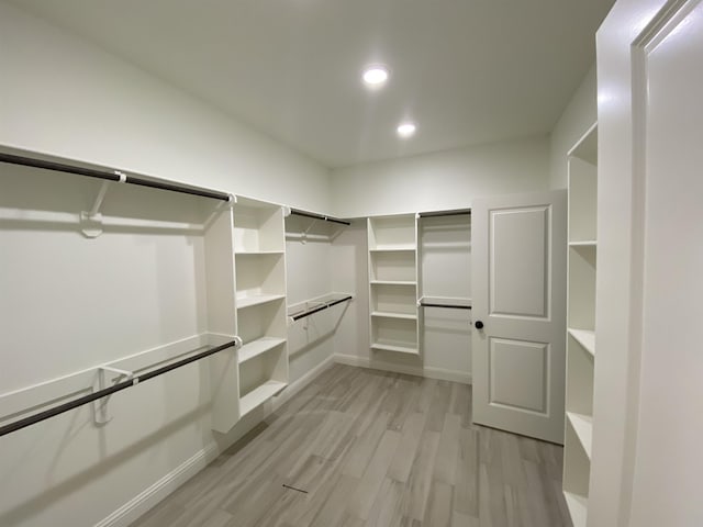 walk in closet featuring light hardwood / wood-style flooring