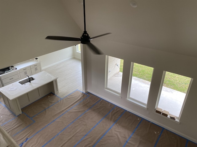 interior space featuring ceiling fan and vaulted ceiling