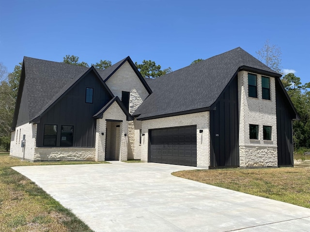 view of front of property with a front yard and a garage