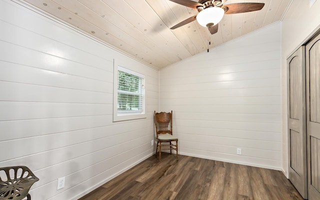 sitting room featuring ceiling fan, dark hardwood / wood-style floors, lofted ceiling, wooden walls, and wood ceiling