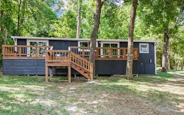 rear view of property featuring a wooden deck