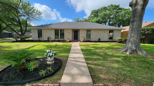 5925 Woodway Dr, Beaumont, TX 77707 - ranch-style house with a shingled roof, a front yard, and stucco siding