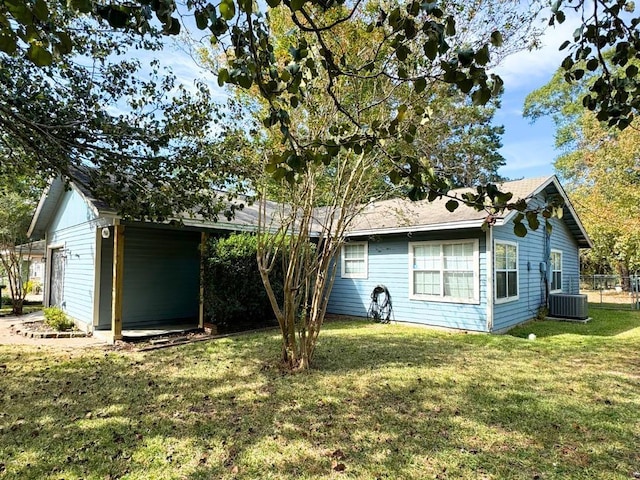 exterior space featuring a lawn and central AC unit