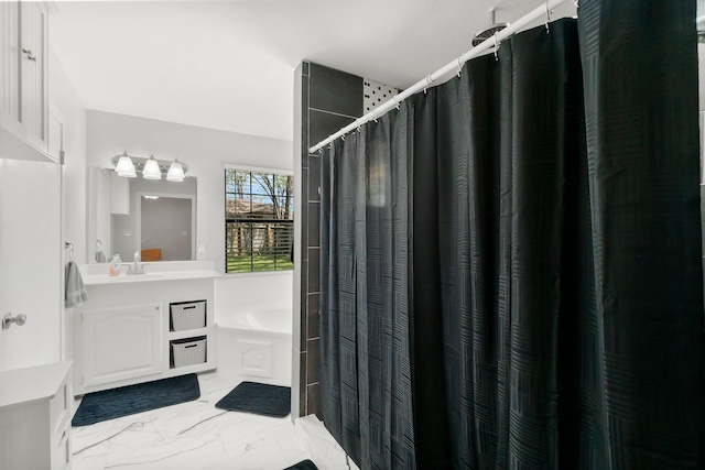 bathroom with a tub, a shower with curtain, marble finish floor, and vanity