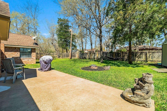 view of yard with a patio, a fire pit, and a fenced backyard