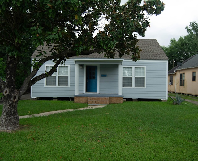2716 22nd St, Port Arthur, TX 77640 - bungalow featuring a front yard, a shingled roof, and covered porch