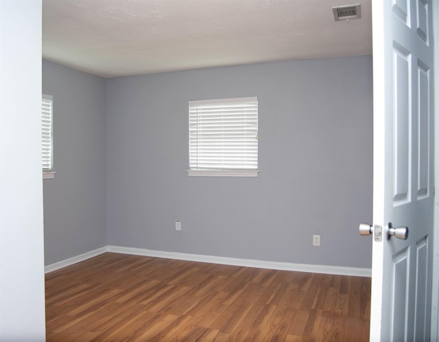 2716 22nd St, Port Arthur, TX 77640 - empty room featuring dark wood finished floors and baseboards